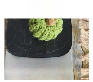 Detail shot showing a small knitted green pumpkin weighing 15g on a digital scale
