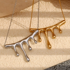Detailed view of liquid metal waterfall pendants in gold and silver stainless steel