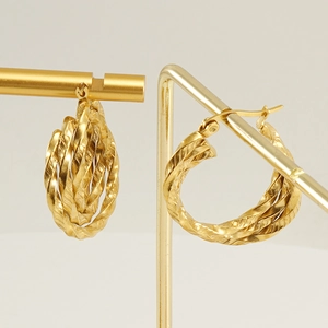18K gold plated multi-layer twisted hoop earrings with tassel design on a gold stand