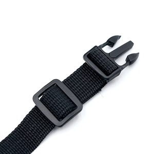 Detailed view of the black plastic buckle and durable nylon webbing for dog harness