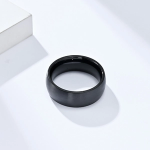 Detail of black stainless steel ring with matte brushed finish and polished inner band