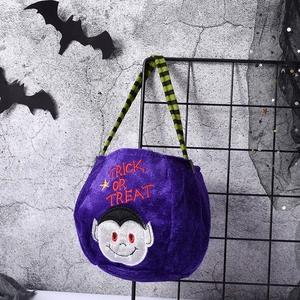 Detail of purple velvet Halloween treat bag featuring vampire embroidery and striped handle
