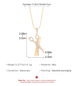 Detailed specs of scissor and comb pendant necklace with clear rhinestone accents