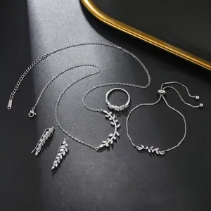Detailed view of silver wheat leaf jewelry set with zircons including necklace and earrings