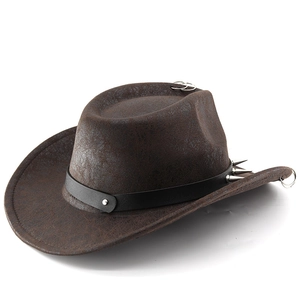Detail of dark brown vintage cowboy hat with punk metal rivets and ring decorations