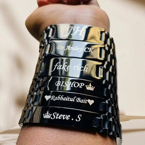 Detailed view of adjustable black stainless steel bracelets with custom name engravings