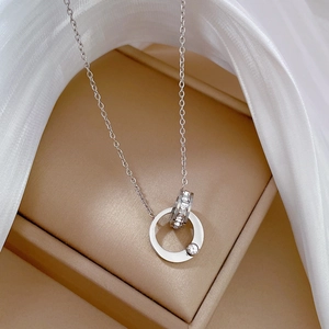 Detail of interlocking silver rings necklace with sparkling diamonds on silk cloth