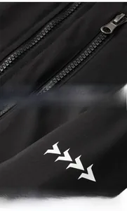 Detail of black windproof jacket featuring smooth zipper and white triple arrow print