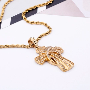 Detail of gold cross pendant with clear zircons on a twisted rope chain necklace