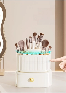 Detail of white 360-degree rotating makeup organizer with a drawer and gold handle
