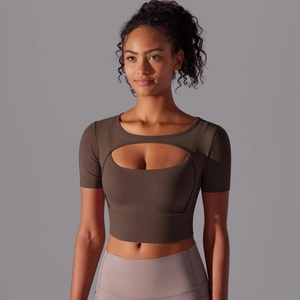 Detailed close-up of dark brown crop top with unique oval chest cutout for yoga