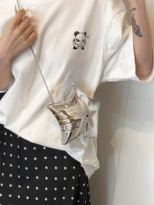Silver mirror star-shaped crossbody bag with rhinestone tassel shown on a model