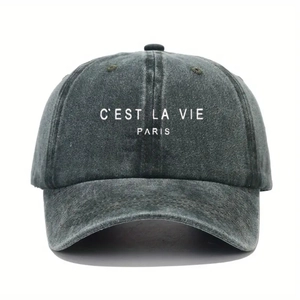 Close-up of C'EST LA VIE PARIS print on washed denim grey baseball cap texture