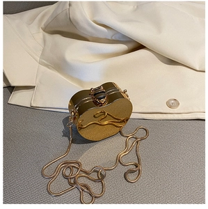 Elegant heart-shaped golden mirror clutch bag with a bee clasp and snake chain strap