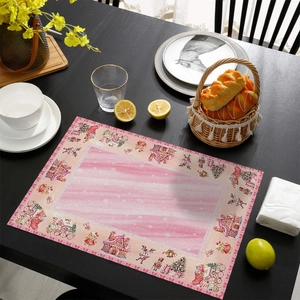 Festive Christmas placemat with gingerbread house and reindeer on a dark wood dining table