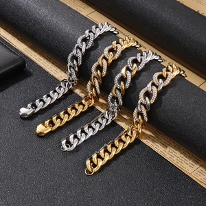 Detail of iced out Cuban link bracelet in gold and silver on vintage background