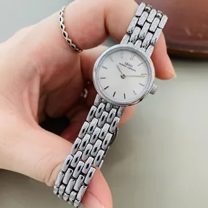 Close-up of IBSO silver steel band watch featuring a mother-of-pearl dial and metal strap
