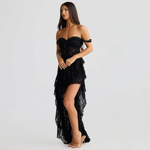 Detail of black strapless lace dress featuring ruffled asymmetric hem and sheer fabric