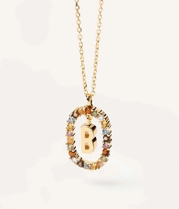 Close-up of gold necklace with letter B pendant and colorful inlaid crystals