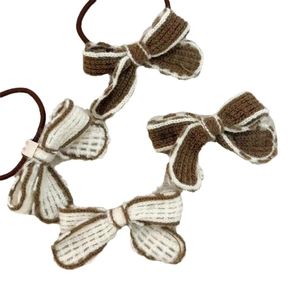 Hand-knitted bow hair accessories in brown and cream white yarn, set of four
