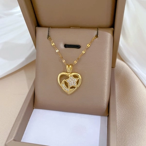 Elegant gold heart necklace with star and moon crystals in a premium jewelry box