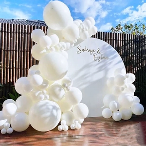 Elegant assortment of round white macaron balloons in varied sizes for wedding party decor