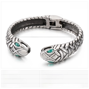 Detail view of steel snake bracelet showing woven texture, green zircon eyes and dimensions