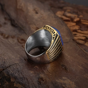 Detail of vintage two-tone stainless steel ring featuring a square blue gemstone inlay