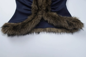 Detailed close-up of dark blue slim-fit jacket with premium brown faux fur trim finish