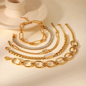 Close-up of golden stainless steel bracelet set with zircon stones and cuban links