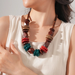 Detailed close-up of ethnic wood bead necklace with brown, red and teal faceted beads