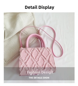 Close-up of pink denim tote bag featuring fringe rhombic texture and handle details
