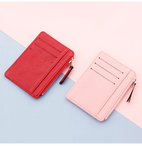 Detail view of pink and red ultra-thin card holders with litchi grain texture and zipper