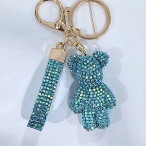 Detailed close-up of blue rhinestone crystal bear keychain with matching hand strap