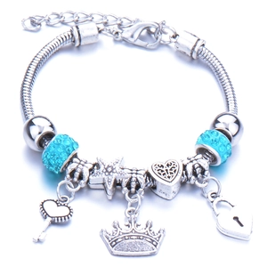 Silver charm bracelet with turquoise beads, crown and heart charms on a snake chain