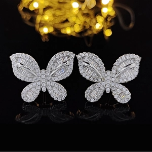 Elegant 925 silver butterfly stud earrings with sparkling pavé crystals on black mirror