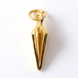 Macro shot of gold cone pendant with smooth metallic texture and integrated top jump ring