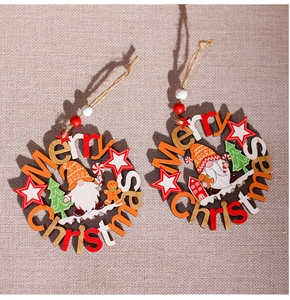 Detail of wooden Merry Christmas wreath ornaments with cut-out Santa and gingerbread man