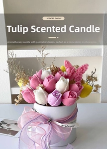 Detail of tulip-shaped scented candles set in a white gift box with bow ribbon
