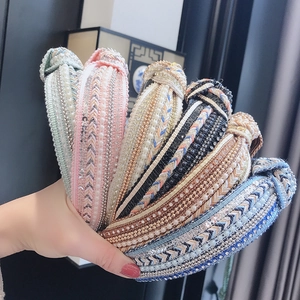 Close-up of bohemian padded headbands with colorful beads and pearl embellishments