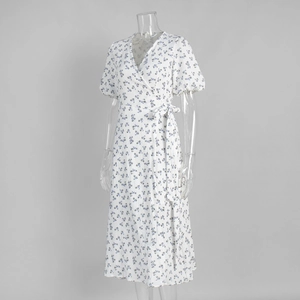 Close-up of blue floral print cotton wrap dress featuring V-neck and puff sleeves