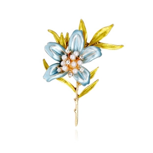 Close-up of elegant blue enamel flower brooch with sparkling pearls and rhinestones