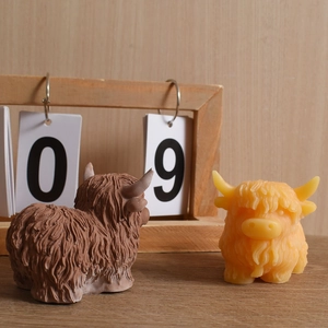 Detail of Highland Cow candle holders with realistic fur textures in brown and yellow