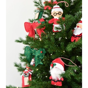 Christmas felt ornaments set with Santa and bows hanging on a festive green Xmas tree