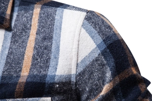 Macro shot of blue and brown plaid shirt showing precise stitching and soft flannel texture