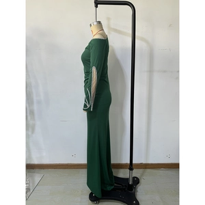 Detail of dark green evening dress with silver rhinestones and hollow-out sleeve design