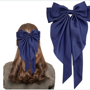 Large navy blue satin bow hair clip with long ribbons and elegant silk-like finish