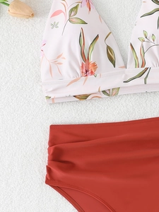 Close-up of floral print halter top with high-waisted ruched brown bikini bottoms