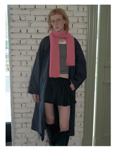 Full body look featuring a pink wool knit scarf paired with a navy trench coat and boots
