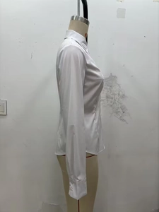 Side view of slim-fit white long-sleeved shirt with turn-down collar on a mannequin